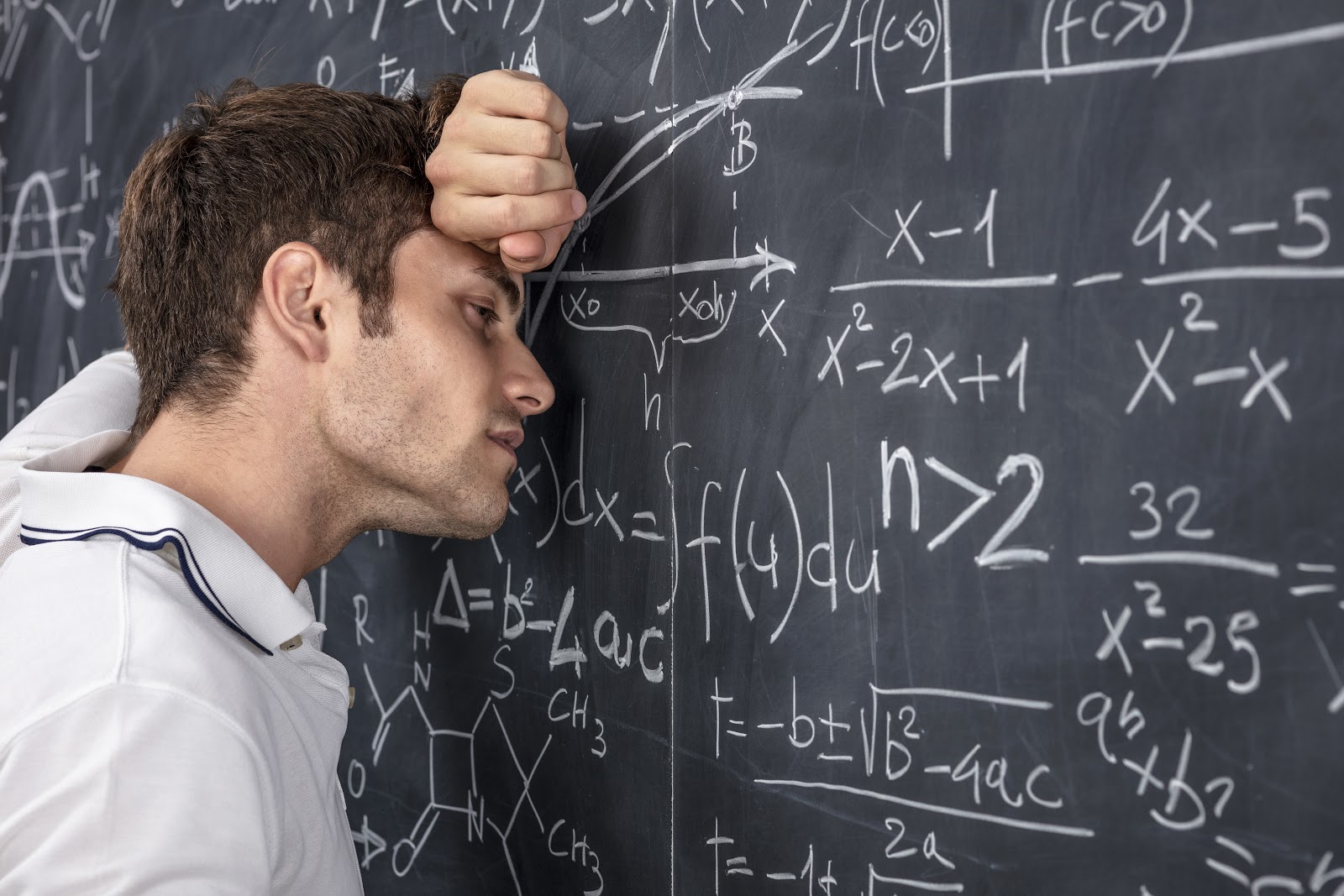 stressed student leans on classic chalkboard